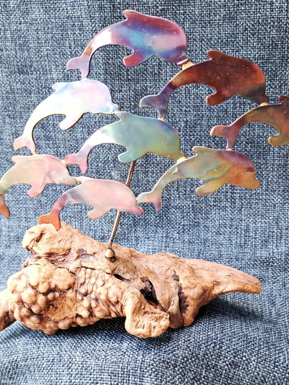 BRASS DOLPHINS MOUNTED ON DRIFTWOOD WITH IRIDESCENT COLORS ON DOLPHINS